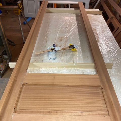 Mahogany panel door being finished on the bench