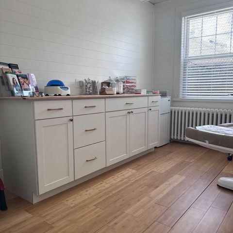 Finished office suite with white shaker cabinetry and shiplap walls