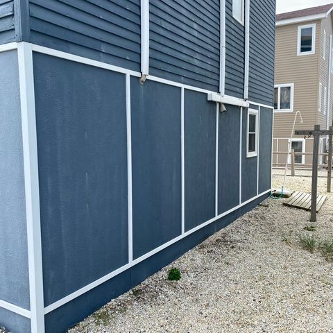 Blue skirting with white trim around a raised shore house