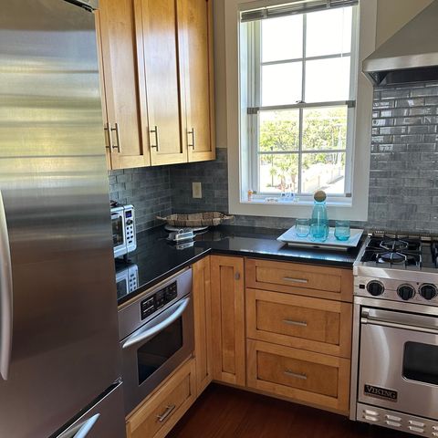 Maple cabinets, stainless appliances and a glass tile backsplash