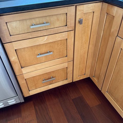 Maple shaker drawers and cabinets over a dark hardwood floor