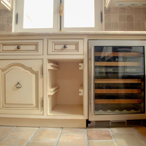 Painted cabinet base with a built-in wine refrigerator
