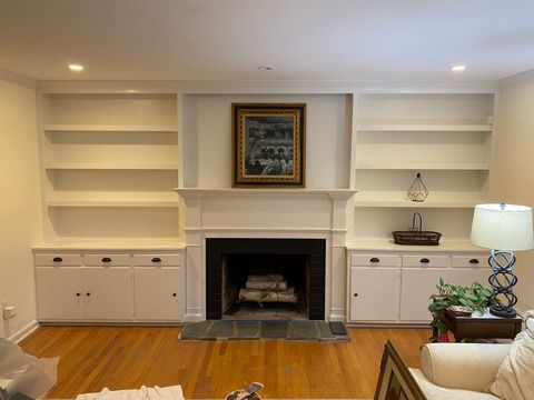Built-in bookshelves and cabinets on both sides of a fireplace