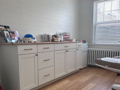 Finished office suite with white shaker cabinetry and shiplap walls