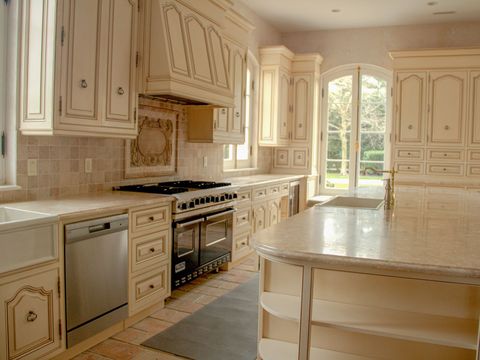 Cream kitchen with a long island and a six-burner range
