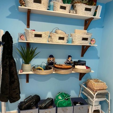 Mudroom with wall shelves and baskets in a new addition